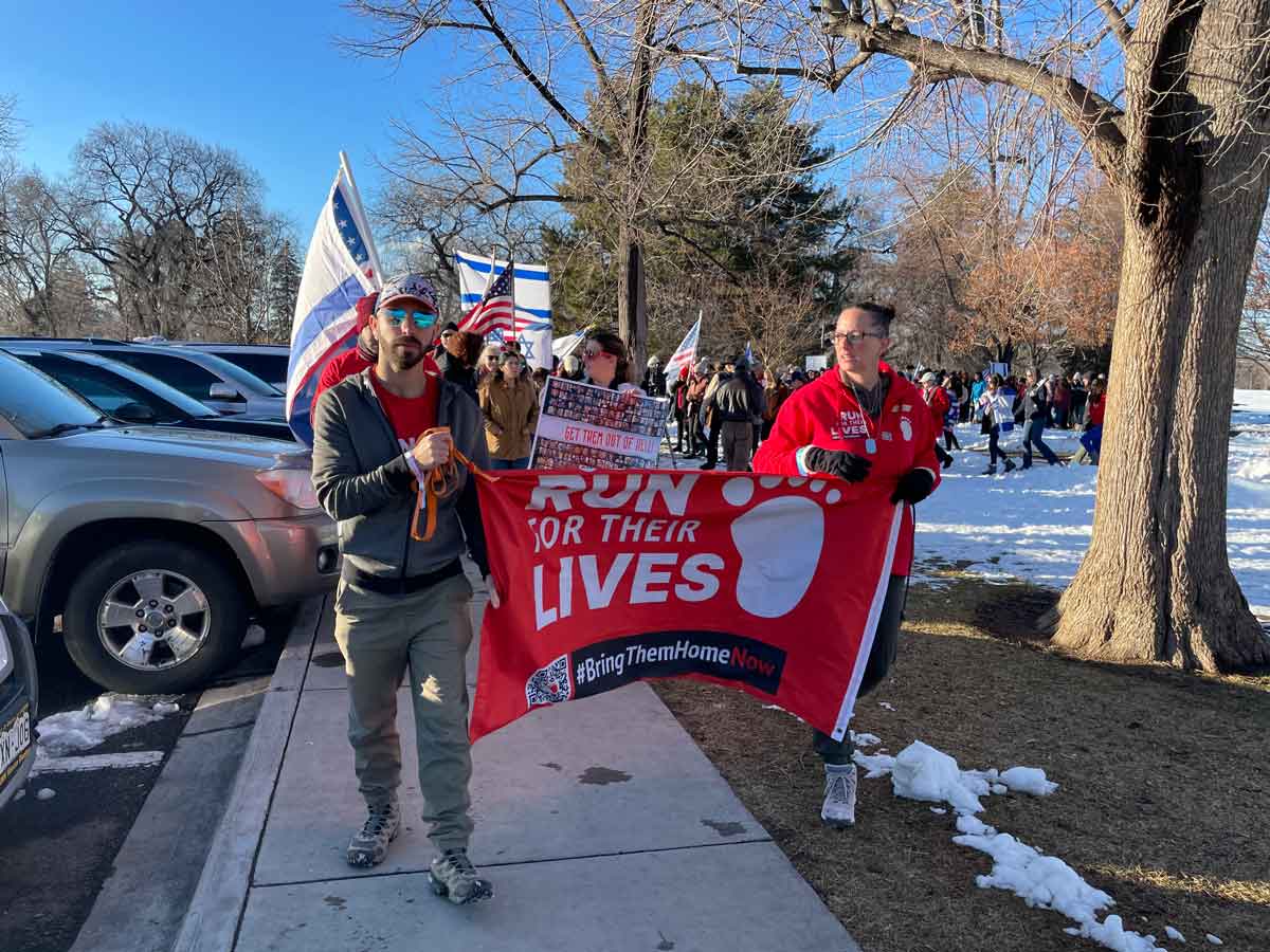 Participants hold banner at Run for Their Lives gathering at Washington Park