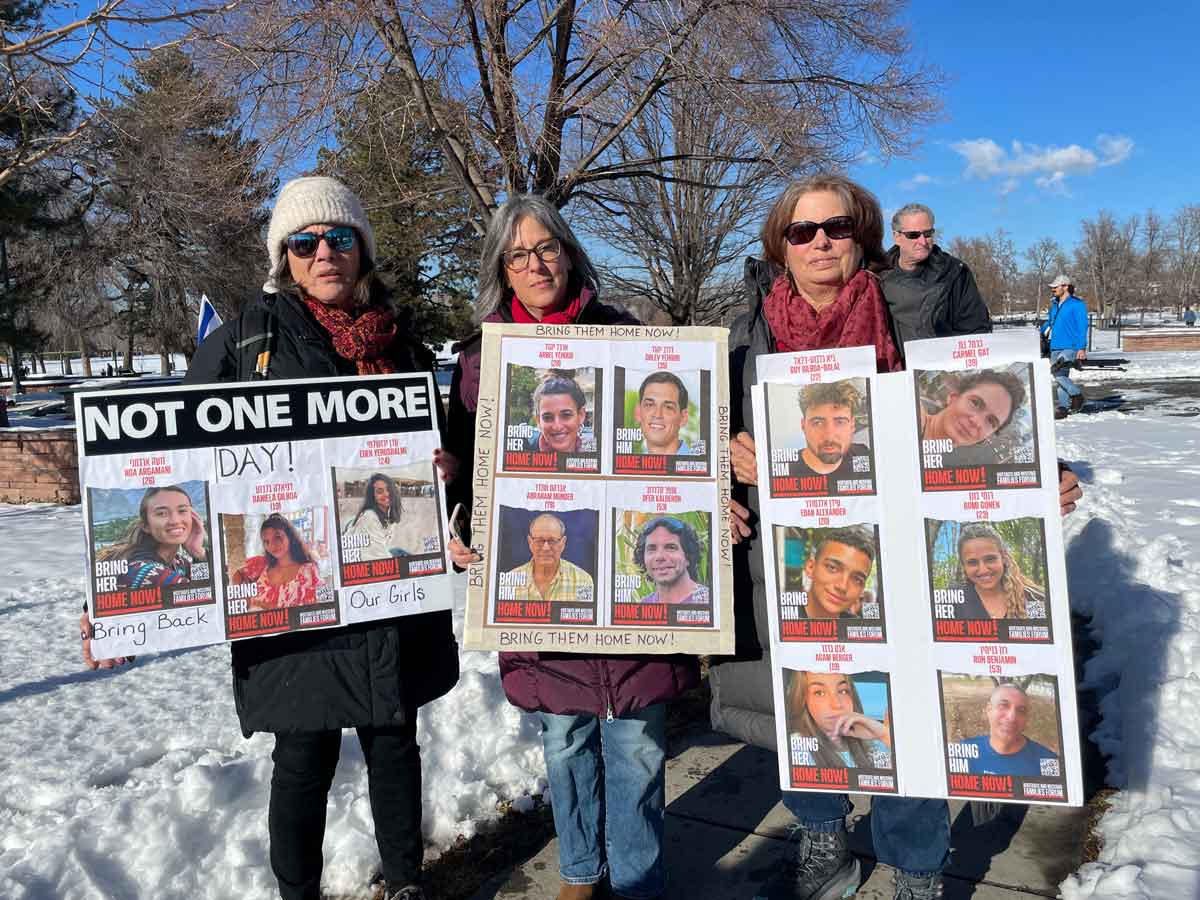 Participants holding posters at Run for Their Lives gathering at Washington Park
